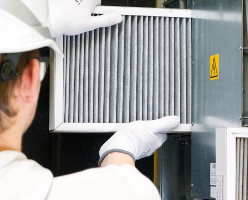 Worker replacing air filter